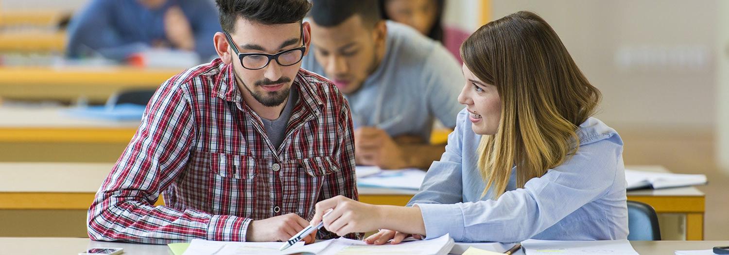 female student discussing materials with male student